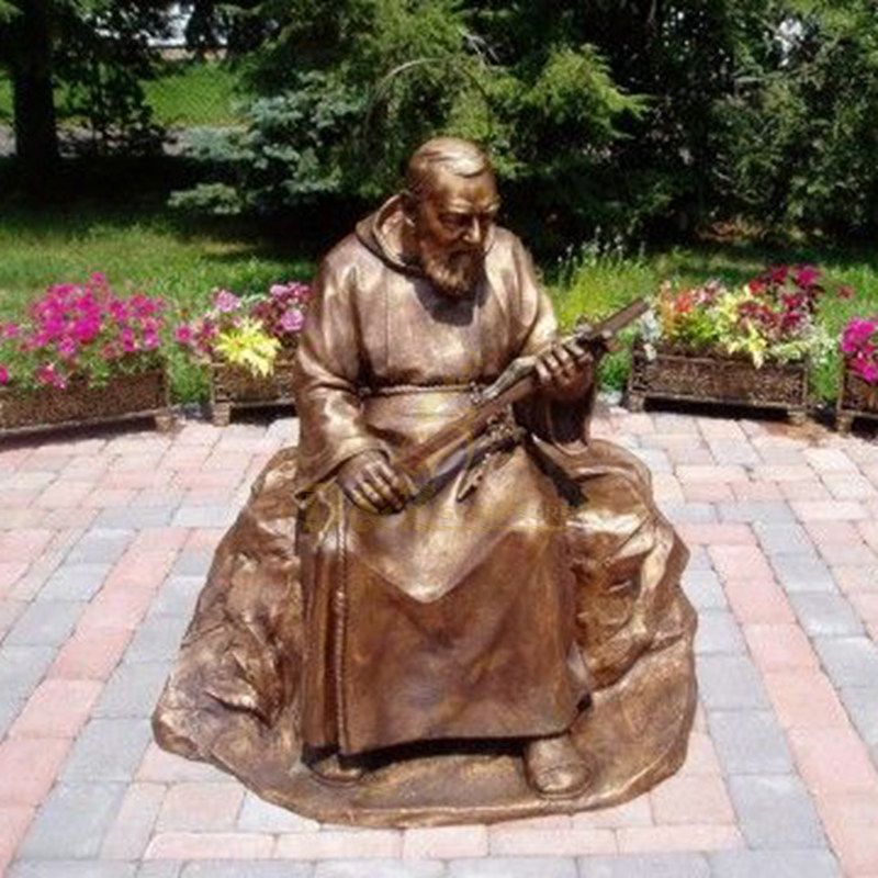 Outdoor Decorated With A Seated Bronze Statue Of St Padre Pio