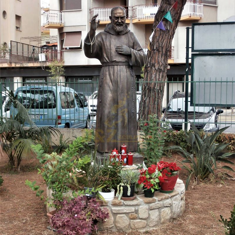Bronze Statue Of St Padre Pio Stands In The Garden