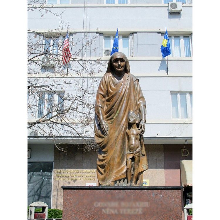 Outdoor bronze standing Teresa religious saint sculpture with boy