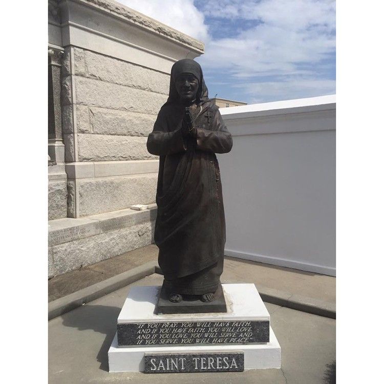 Black life-size folded hands bronze Teresa sculpture