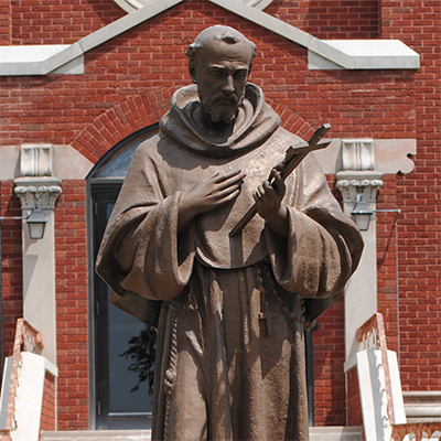 saint francis statue with dog