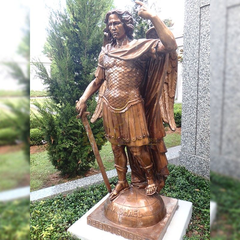 Bronze statue of Archangel Saint Michael stepping on a ball in garden decoration