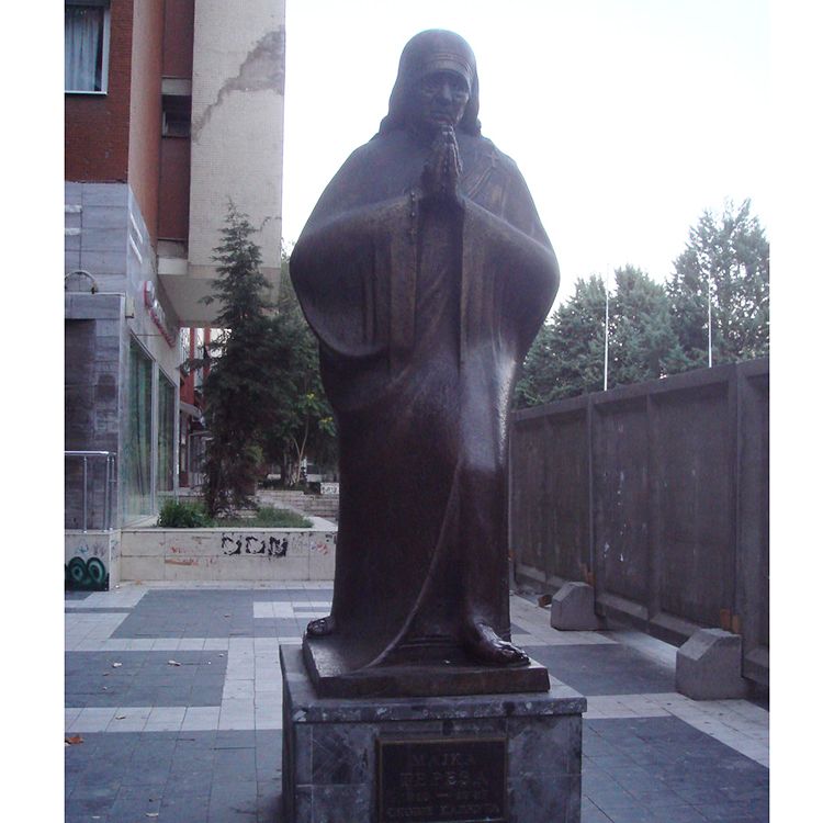 Bronze teresa sculpture with hands folded for prayer